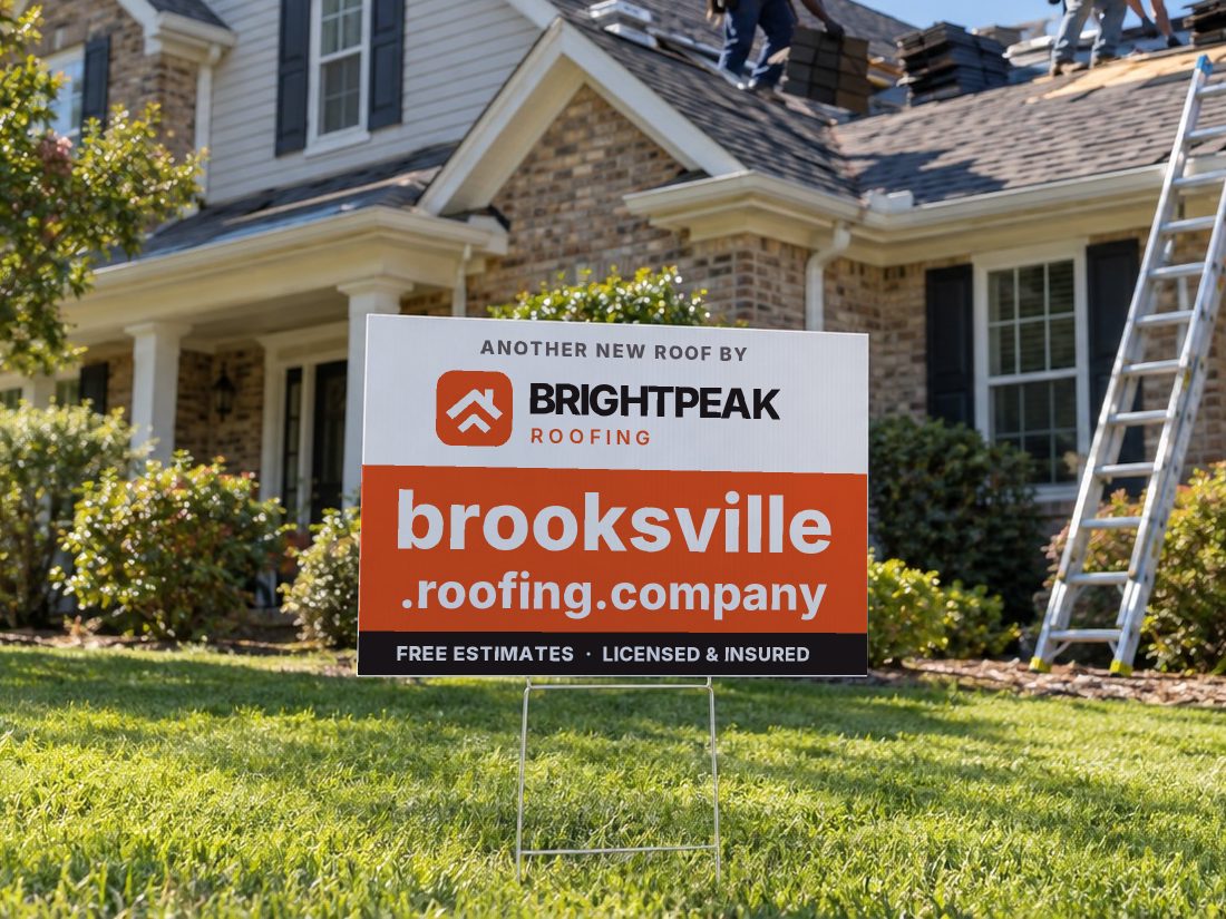 brooksville.roofing.company on a yard sign in front of a house getting a new roof